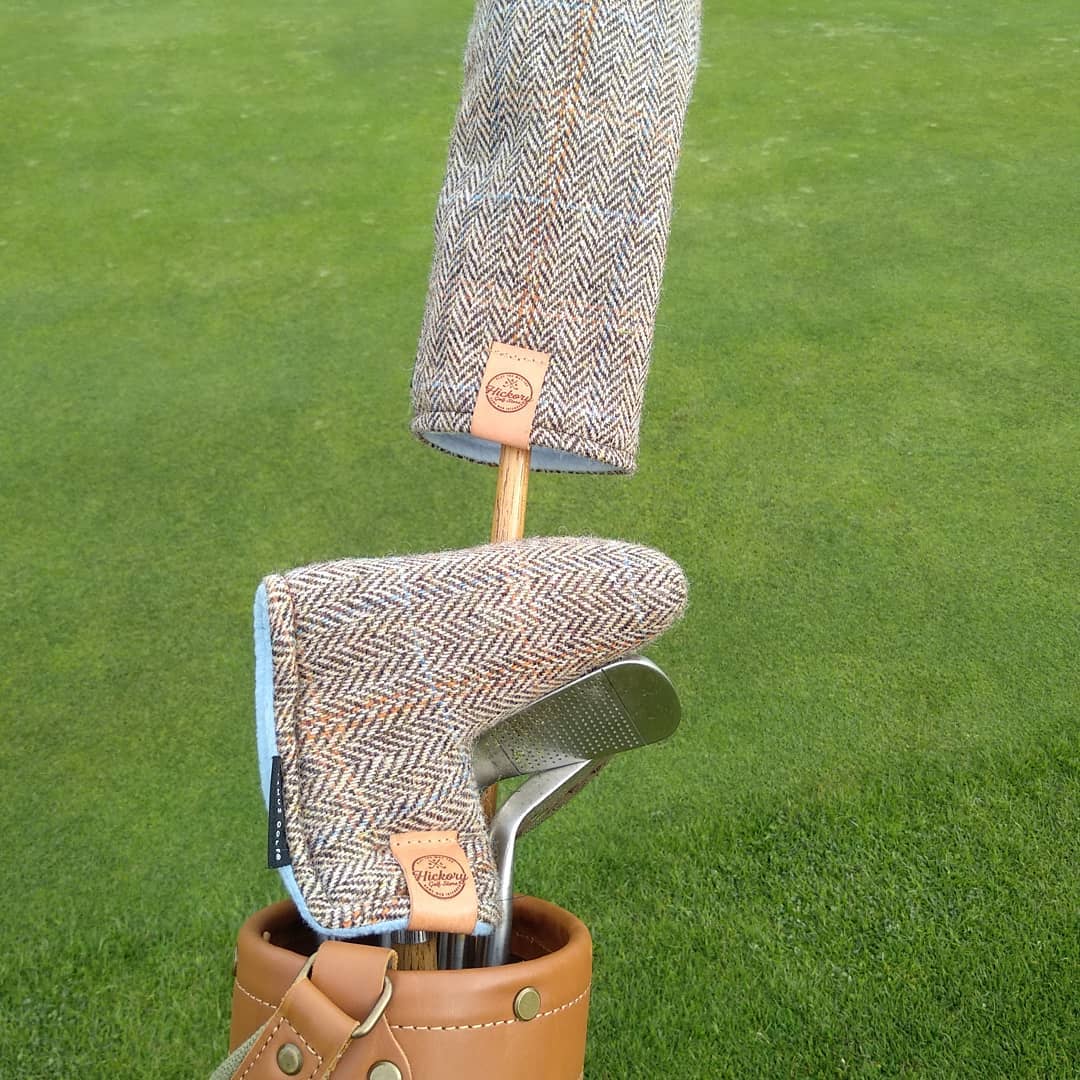 A_set_of_golf_clubs_with_herringbone-patterned_wool_covers.